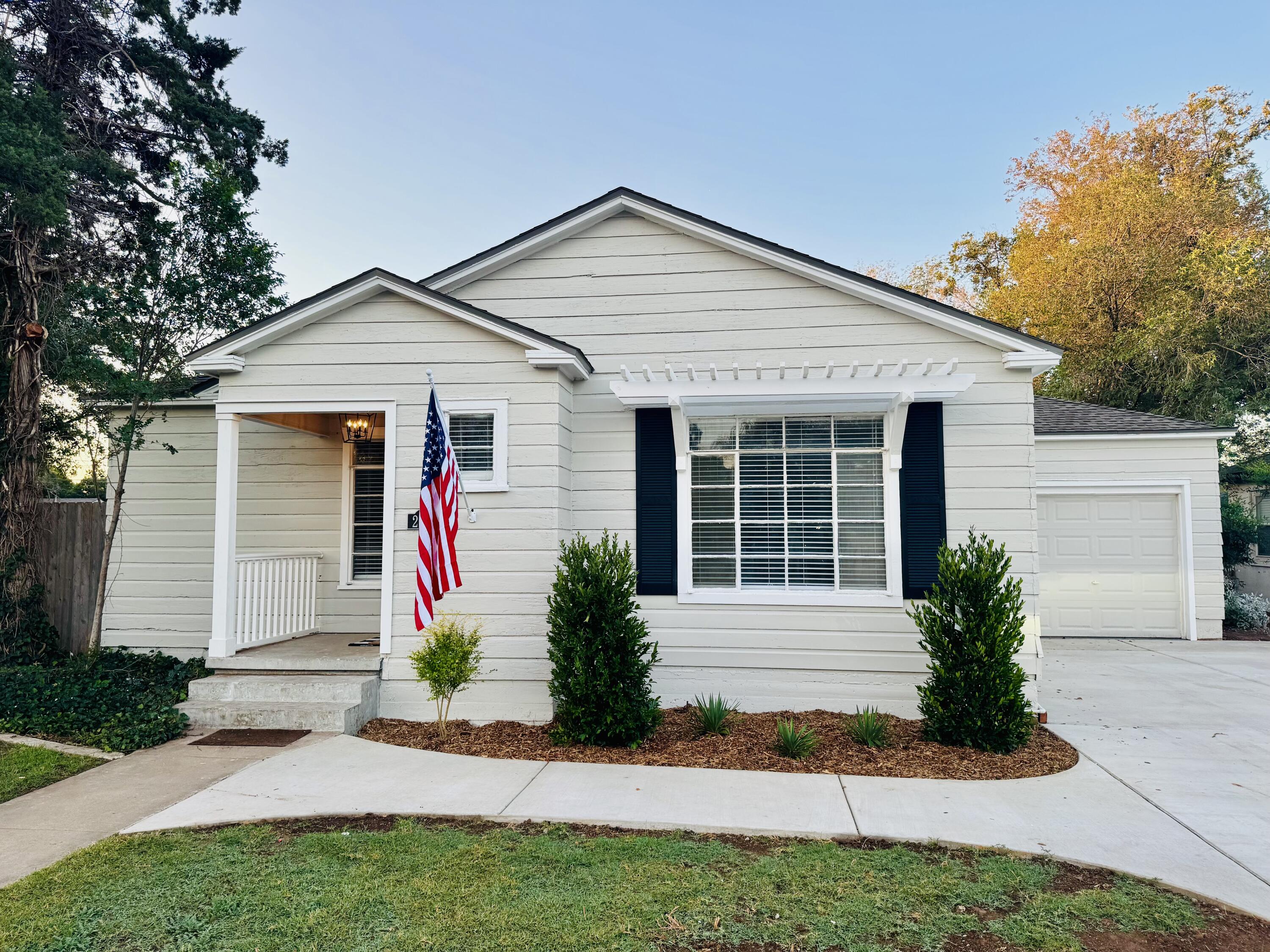 2509 30th Street Lubbock, TX 79410 - Photo 28 of 31 a front view of a house with a yard and outdoor seating
