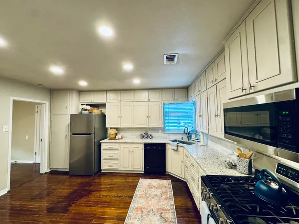 a kitchen with refrigerator and cabinets