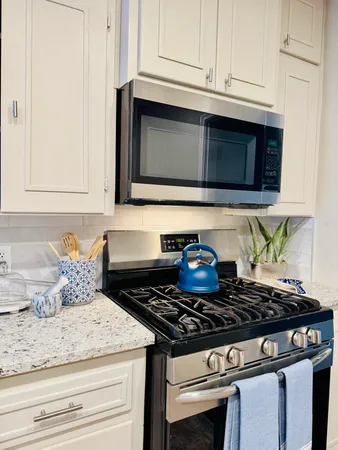 a stove top oven sitting inside of a kitchen