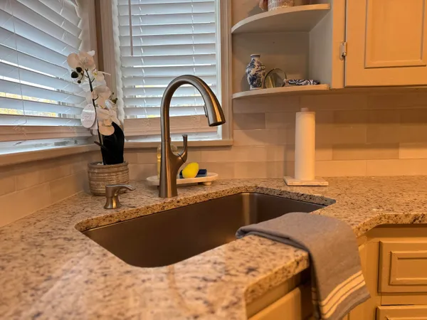a kitchen with a sink and a refrigerator