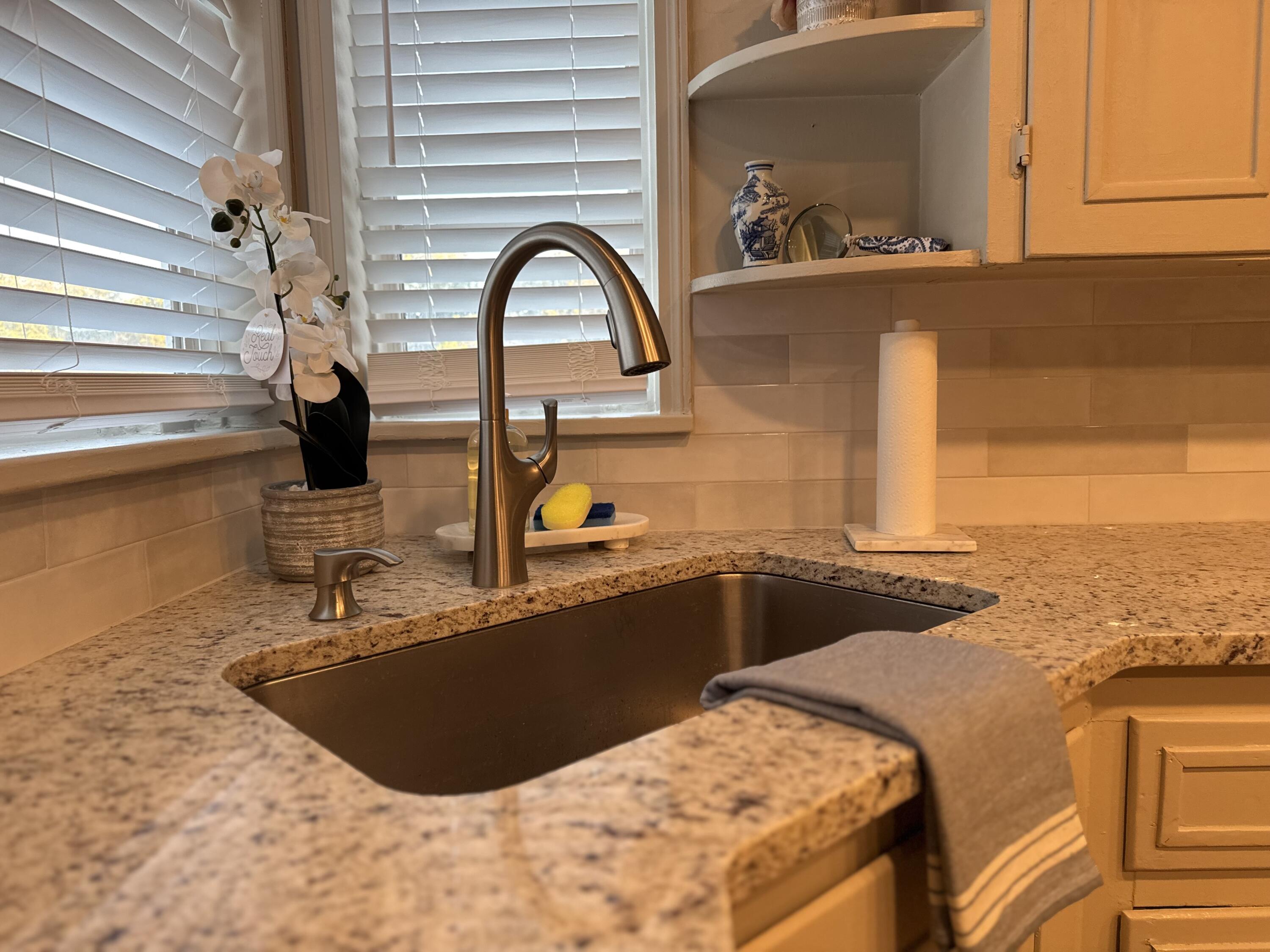 2509 30th Street Lubbock, TX 79410 - Photo 7 of 26 a kitchen with a sink and a refrigerator