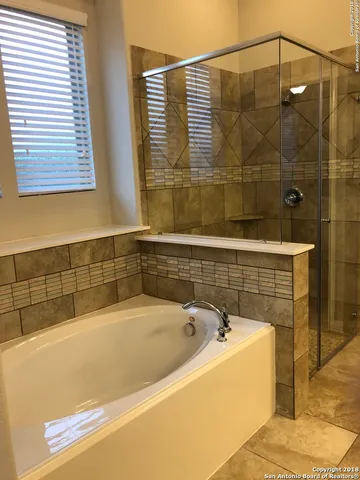 a bathroom with a bathtub and shower