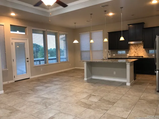 a view of kitchen with a sink and a refrigerator