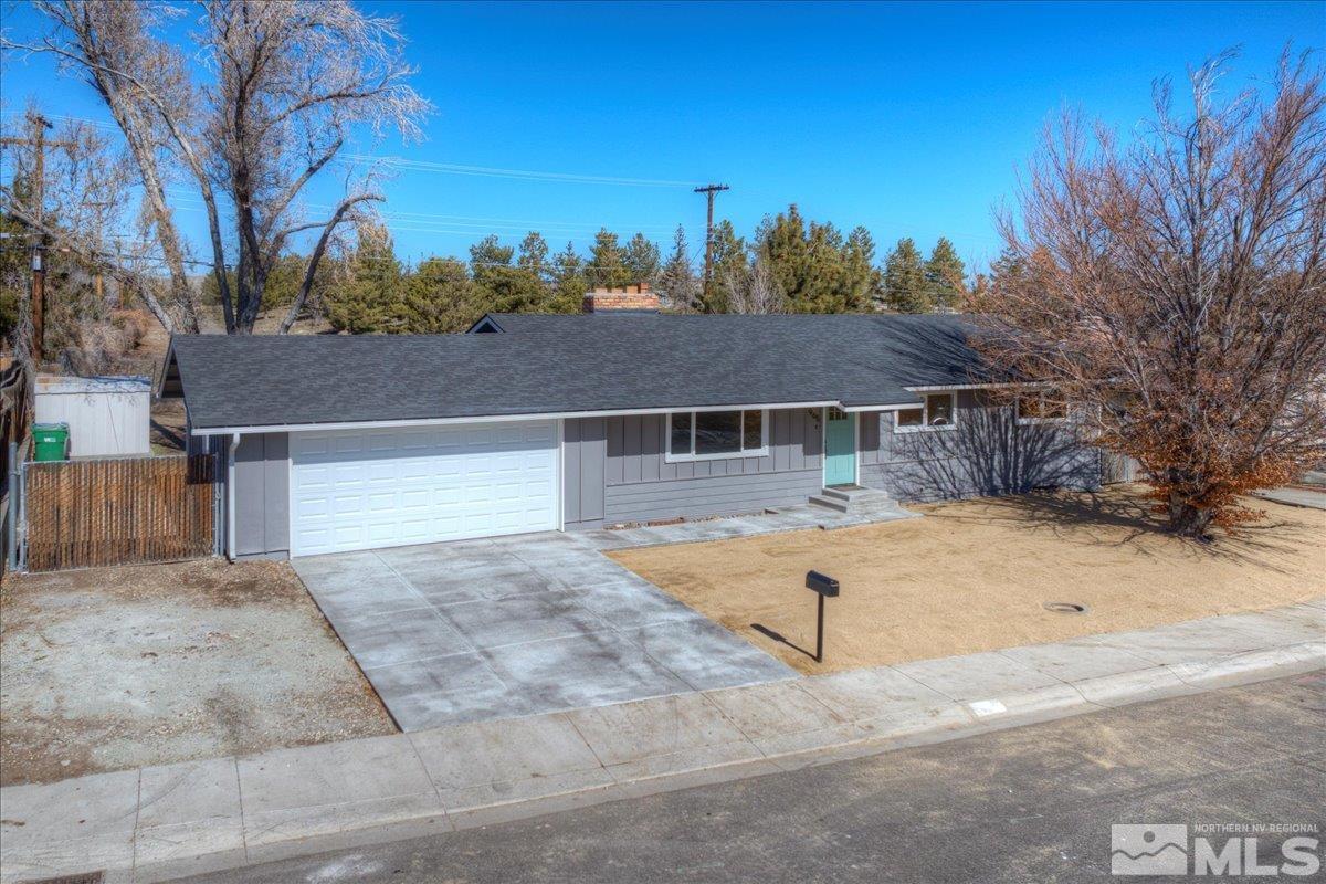 965 Grandview Avenue Reno, NV 89503 - Photo 1 of 34 front view of a house with a yard and trees in the background