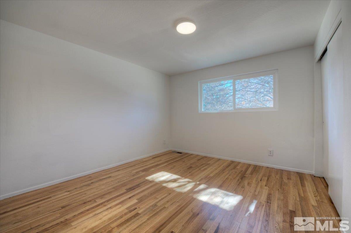965 Grandview Avenue Reno, NV 89503 - Photo 18 of 34 an empty room with wooden floor and windows