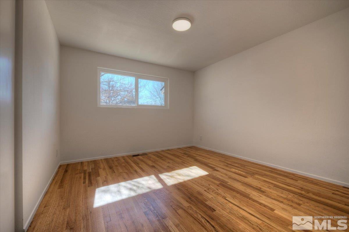 965 Grandview Avenue Reno, NV 89503 - Photo 19 of 34 an empty room with wooden floor and windows