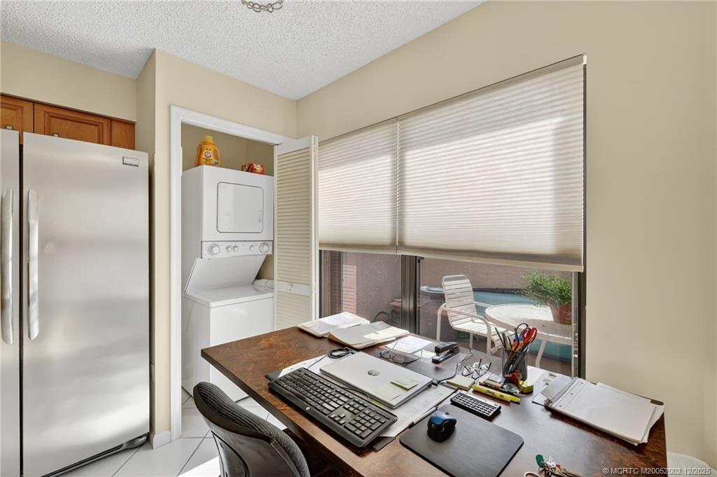 3460 Southeast Martinique Trace, Unit 103 Stuart, FL 34997 - Photo 14 of 42 a view of a workspace with furniture and a window