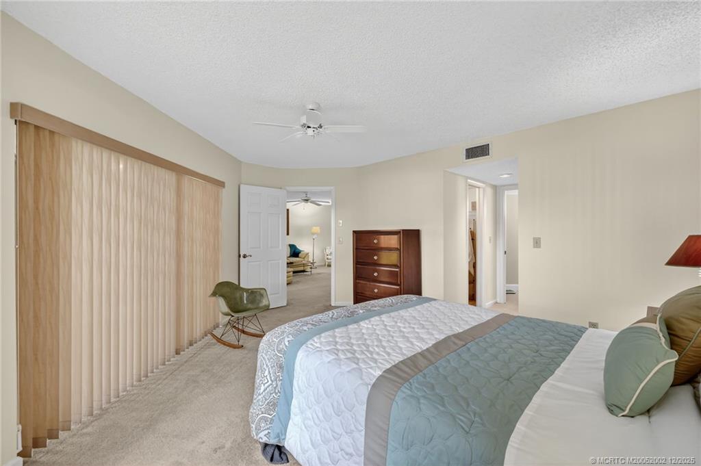 3460 Southeast Martinique Trace, Unit 103 Stuart, FL 34997 - Photo 15 of 42 a bedroom with a bed and a couch
