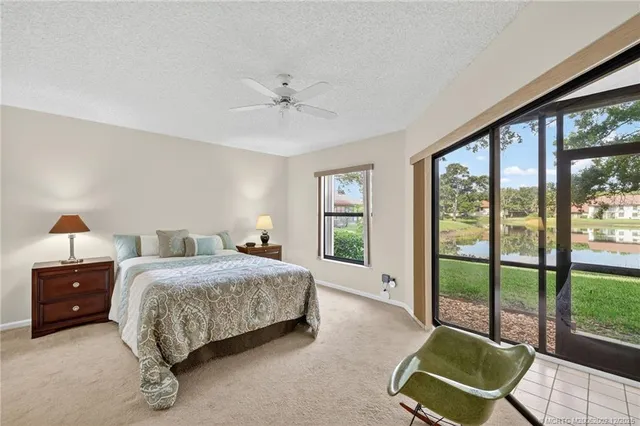 a living room with a bed and large window