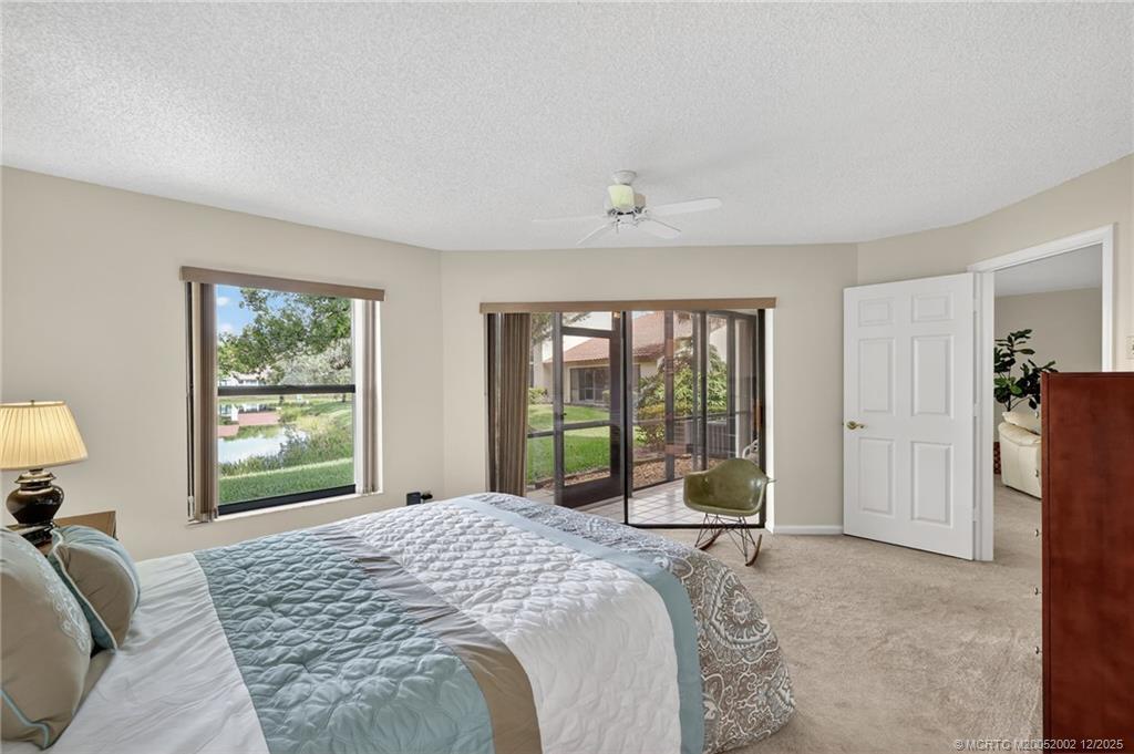 3460 Southeast Martinique Trace, Unit 103 Stuart, FL 34997 - Photo 17 of 42 a bedroom with a large bed and a window