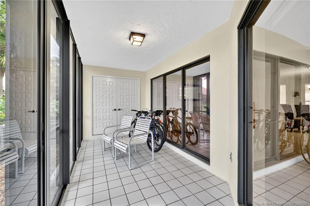 3460 Southeast Martinique Trace, Unit 103 Stuart, FL 34997 - Photo 25 of 42 a view of a hallway with living room and furniture