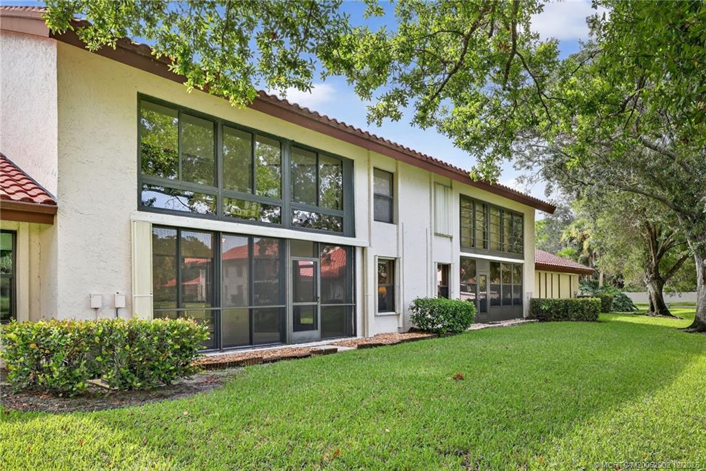 3460 Southeast Martinique Trace, Unit 103 Stuart, FL 34997 - Photo 28 of 42 a view of a house with a garden