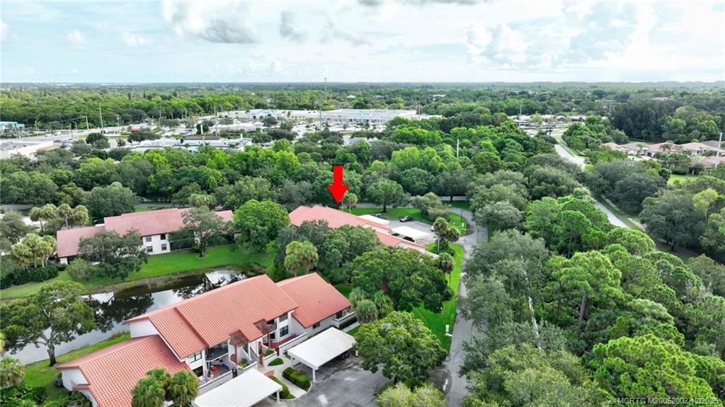3460 Southeast Martinique Trace, Unit 103 Stuart, FL 34997 - Photo 35 of 42 an aerial view of a houses with outdoor space and street view