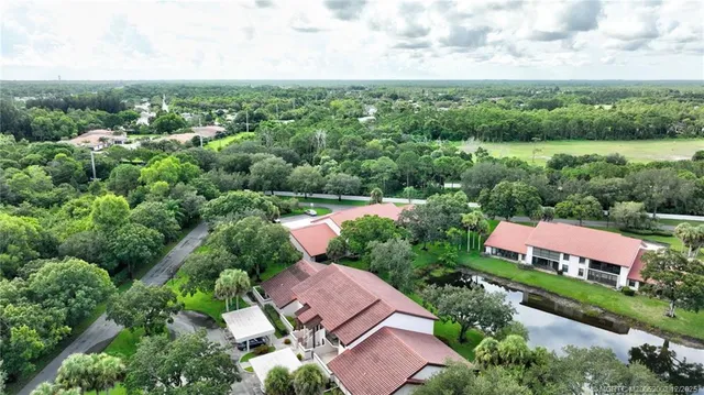 an aerial view of house with yard swimming pool and green space