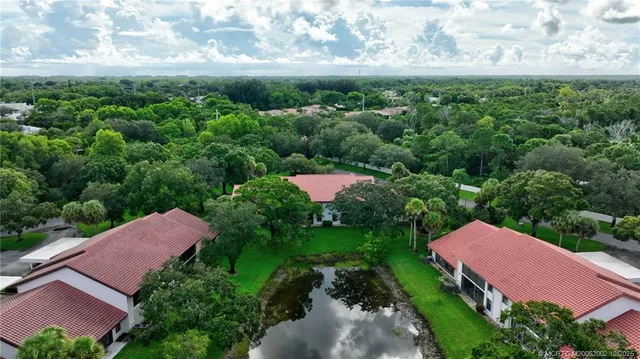 an aerial view of a house with garden space and street view