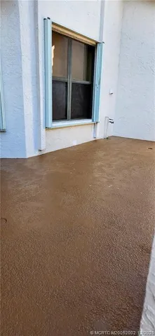 a view of an empty room with a fireplace and a window