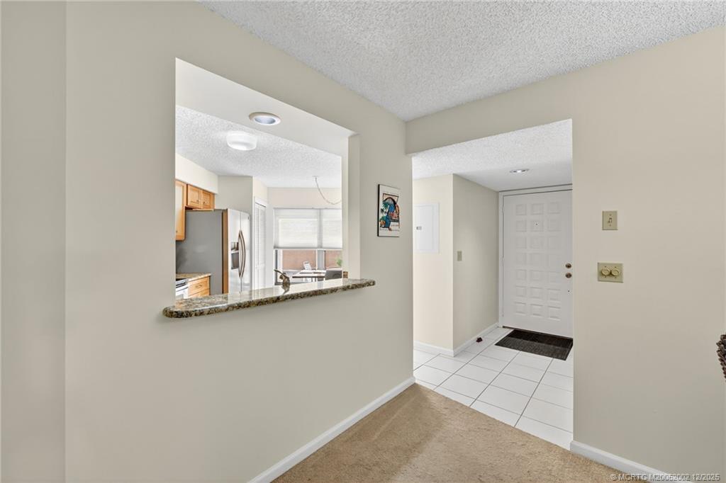 3460 Southeast Martinique Trace, Unit 103 Stuart, FL 34997 - Photo 10 of 42 a view of a kitchen with wooden floor