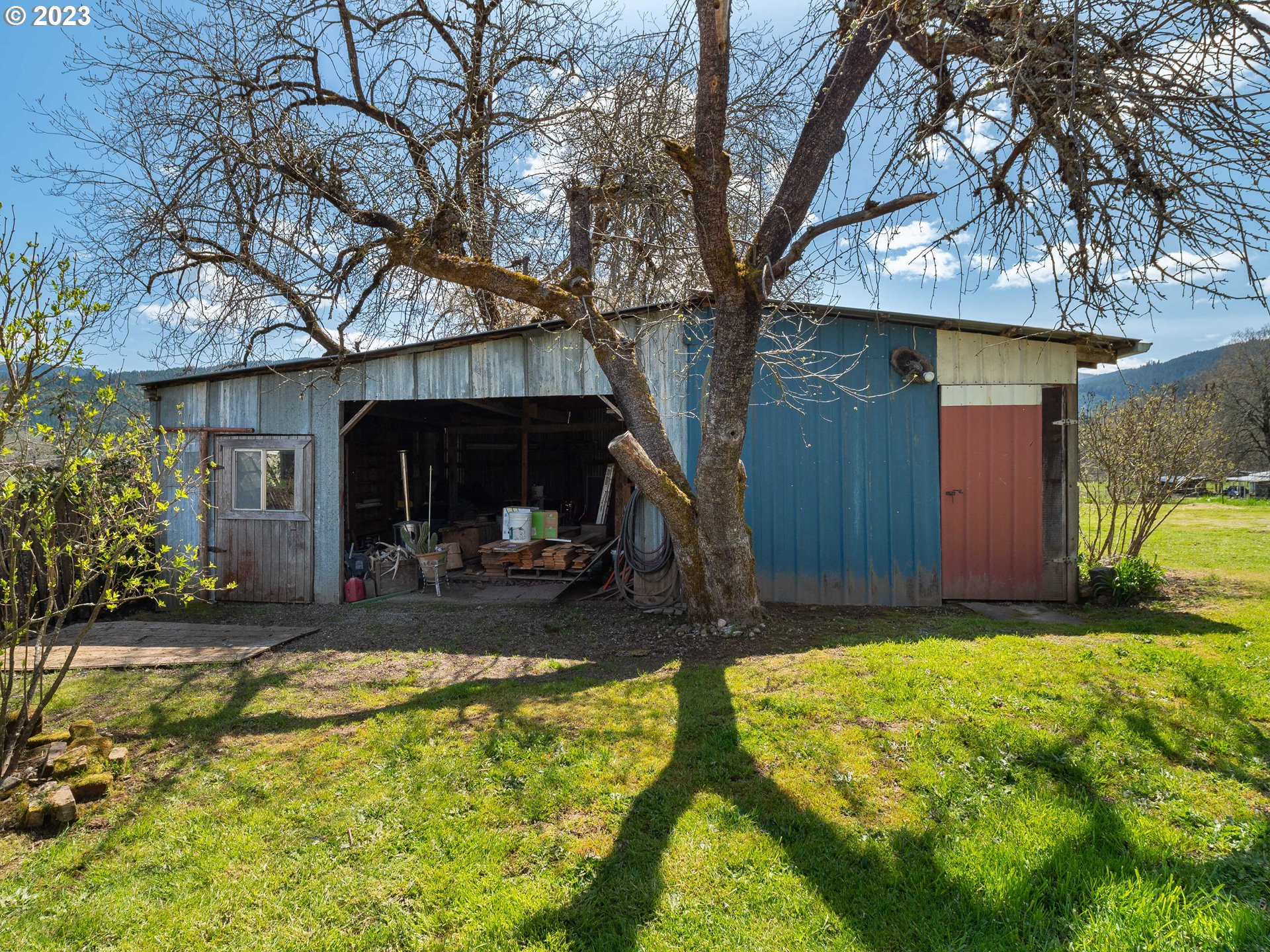 5208 Riddle Bypass Road Riddle, OR 97469 - Photo 34 of 37 a view of a house with a yard patio and a tree