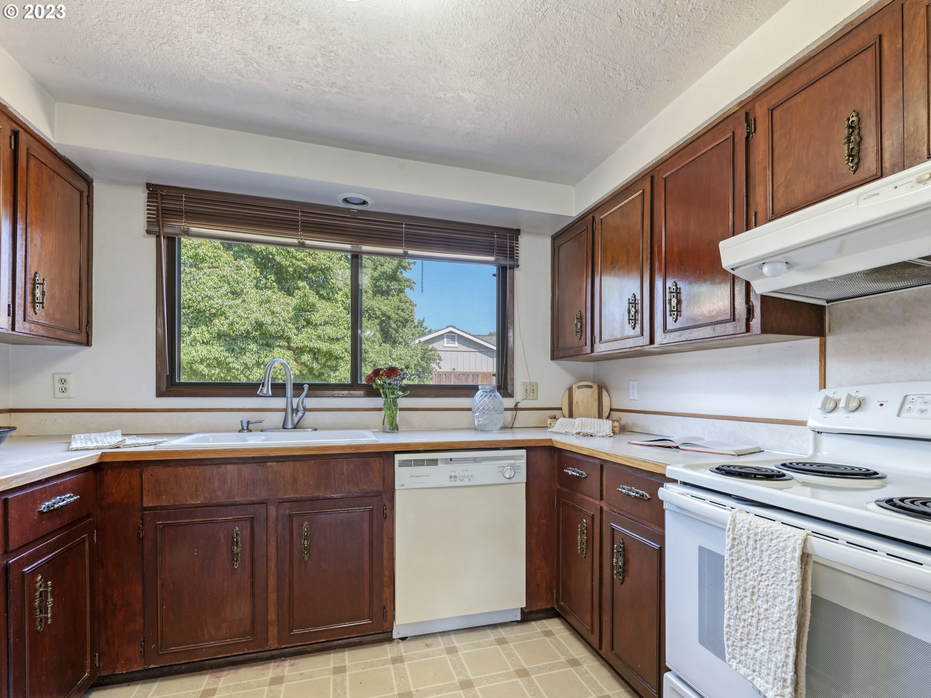 771 Rowan Avenue Springfield, OR 97477 - Photo 13 of 37 a kitchen with a sink stove top oven and cabinets