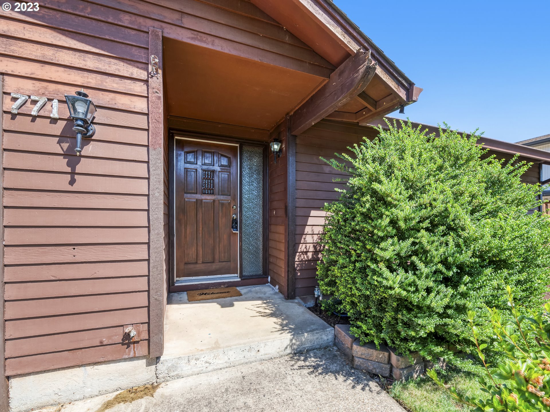 771 Rowan Avenue Springfield, OR 97477 - Photo 5 of 37 a view of a house with a door and wooden walls