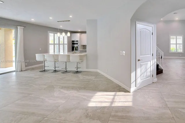 a large kitchen with kitchen island a sink stainless steel appliances and cabinets