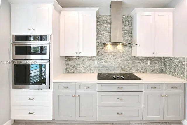 a kitchen with a refrigerator sink and cabinets