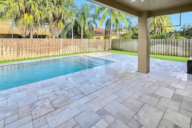 a view of a house with a garden and pathway