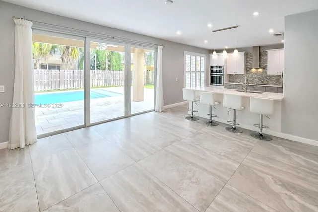 a view of empty room with wooden floor and window