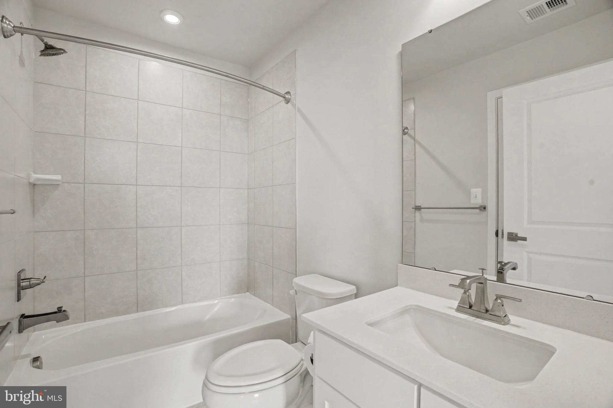 1518 Decatur Street, Unit C Baltimore, MD 21230 - Photo 28 of 42 a bathroom with a bathtub shower sink vanity and toilet