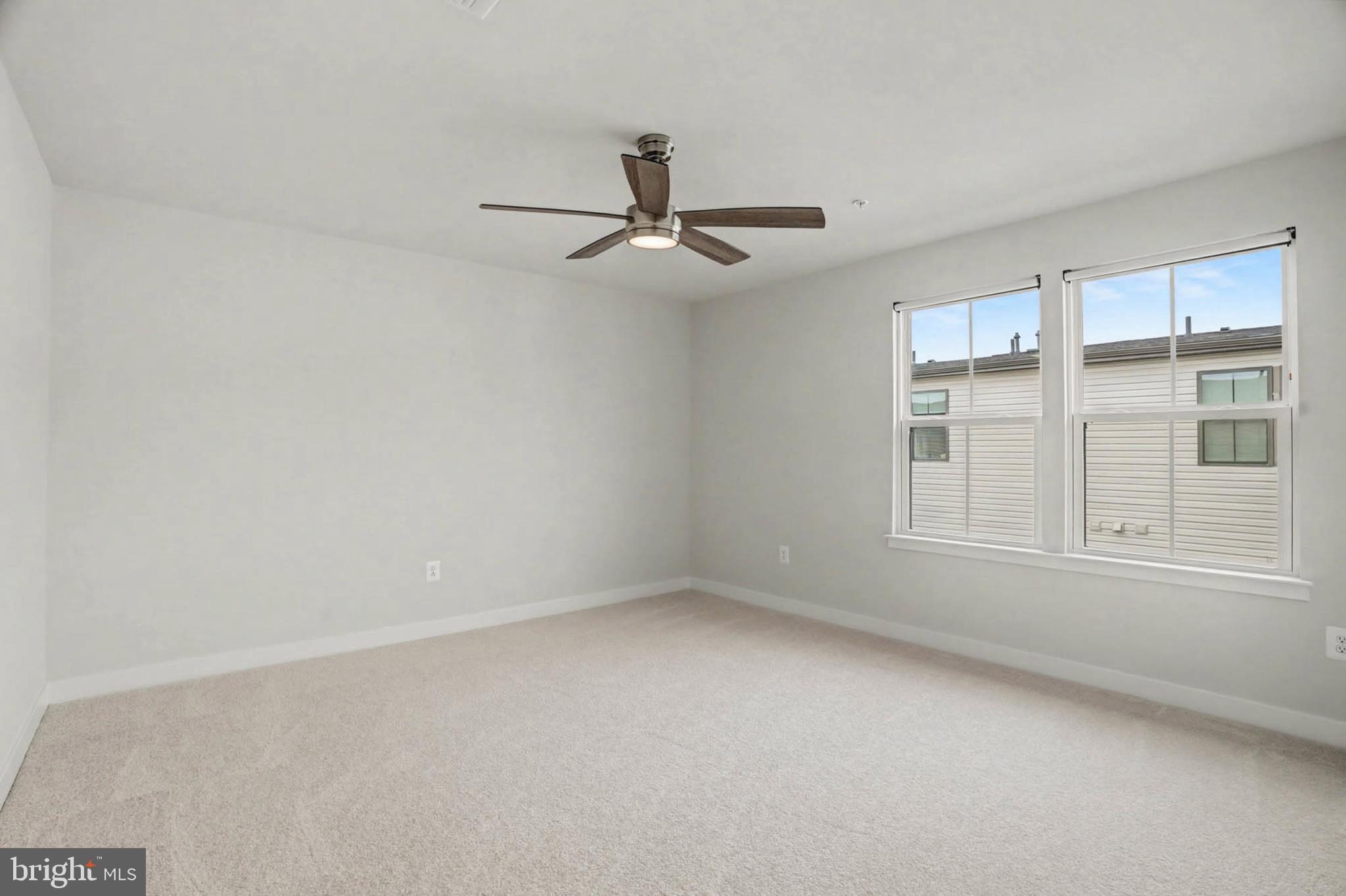 1518 Decatur Street, Unit C Baltimore, MD 21230 - Photo 29 of 42 an empty room with windows and fan