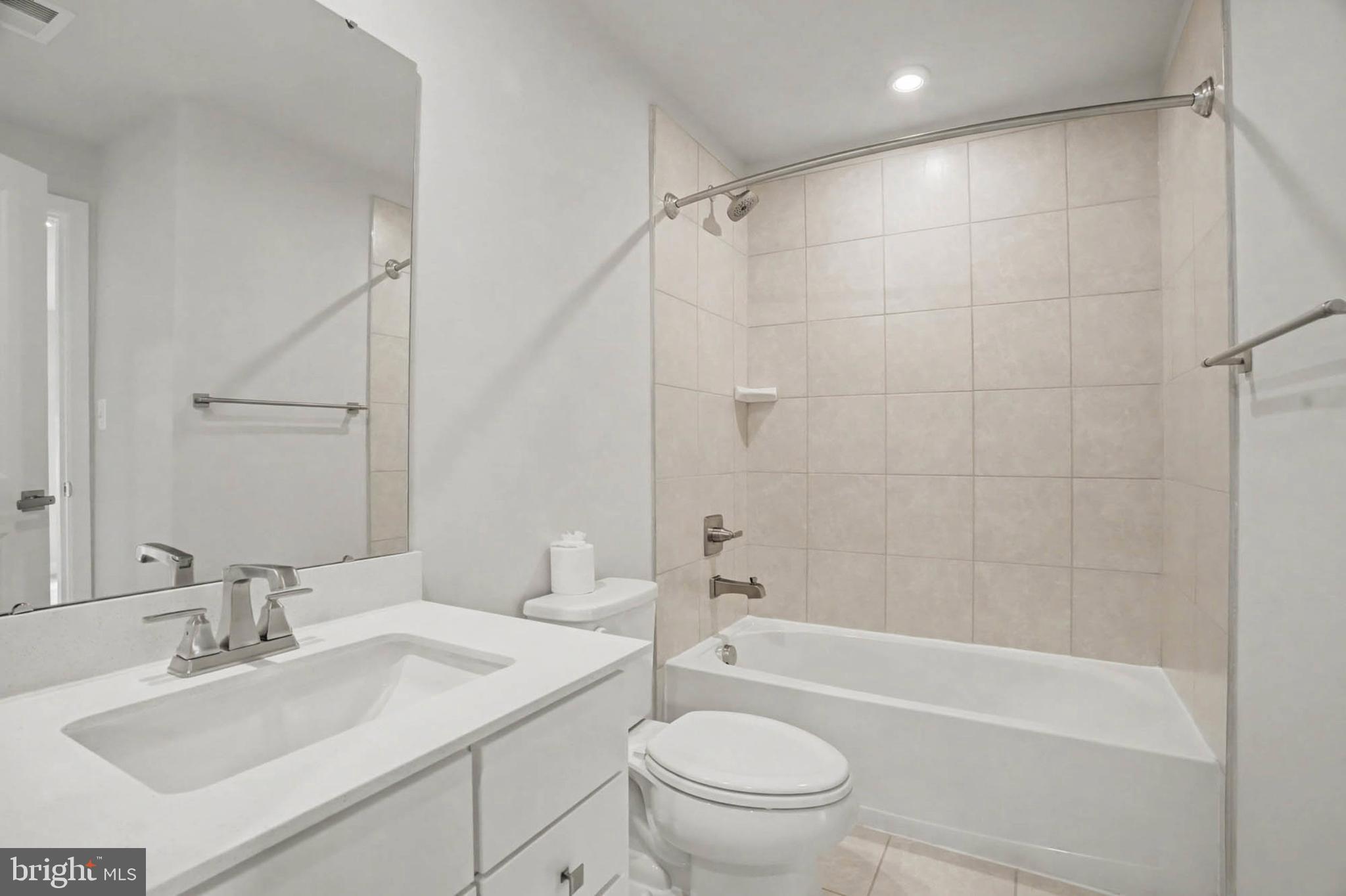 1518 Decatur Street, Unit C Baltimore, MD 21230 - Photo 32 of 42 a bathroom with a sink toilet vanity and shower