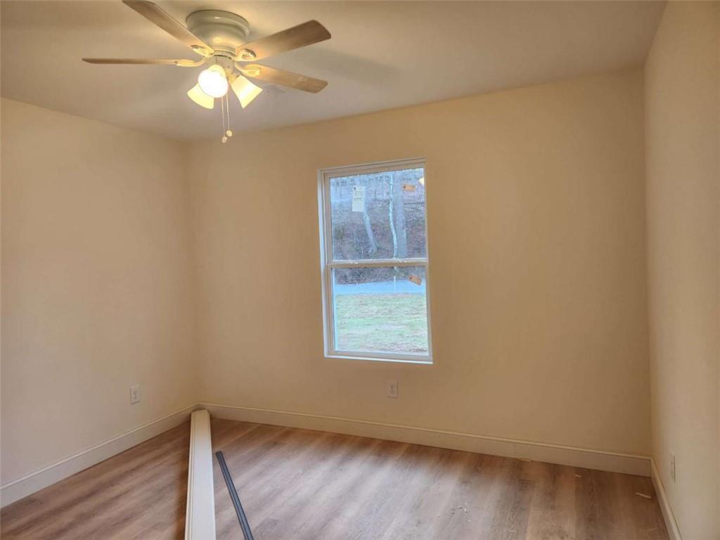 60 Reeves And Norrell Road Dawsonville, GA 30534 - Photo 9 of 11 an empty room with a window and wooden floor