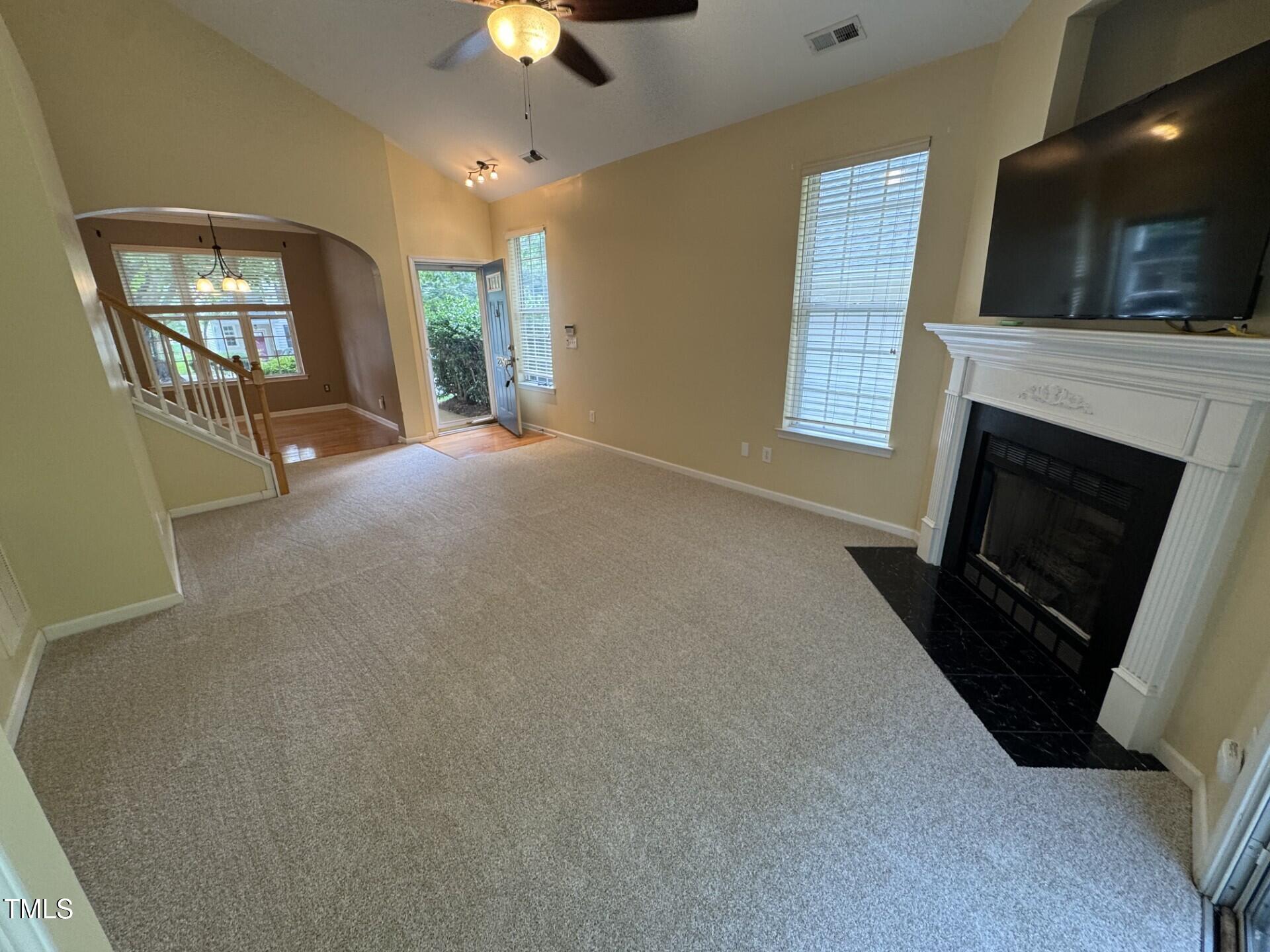 2250 Plum Frost Drive Raleigh, NC 27603 - Photo 3 of 19 a living room with furniture a flat screen tv and a fireplace