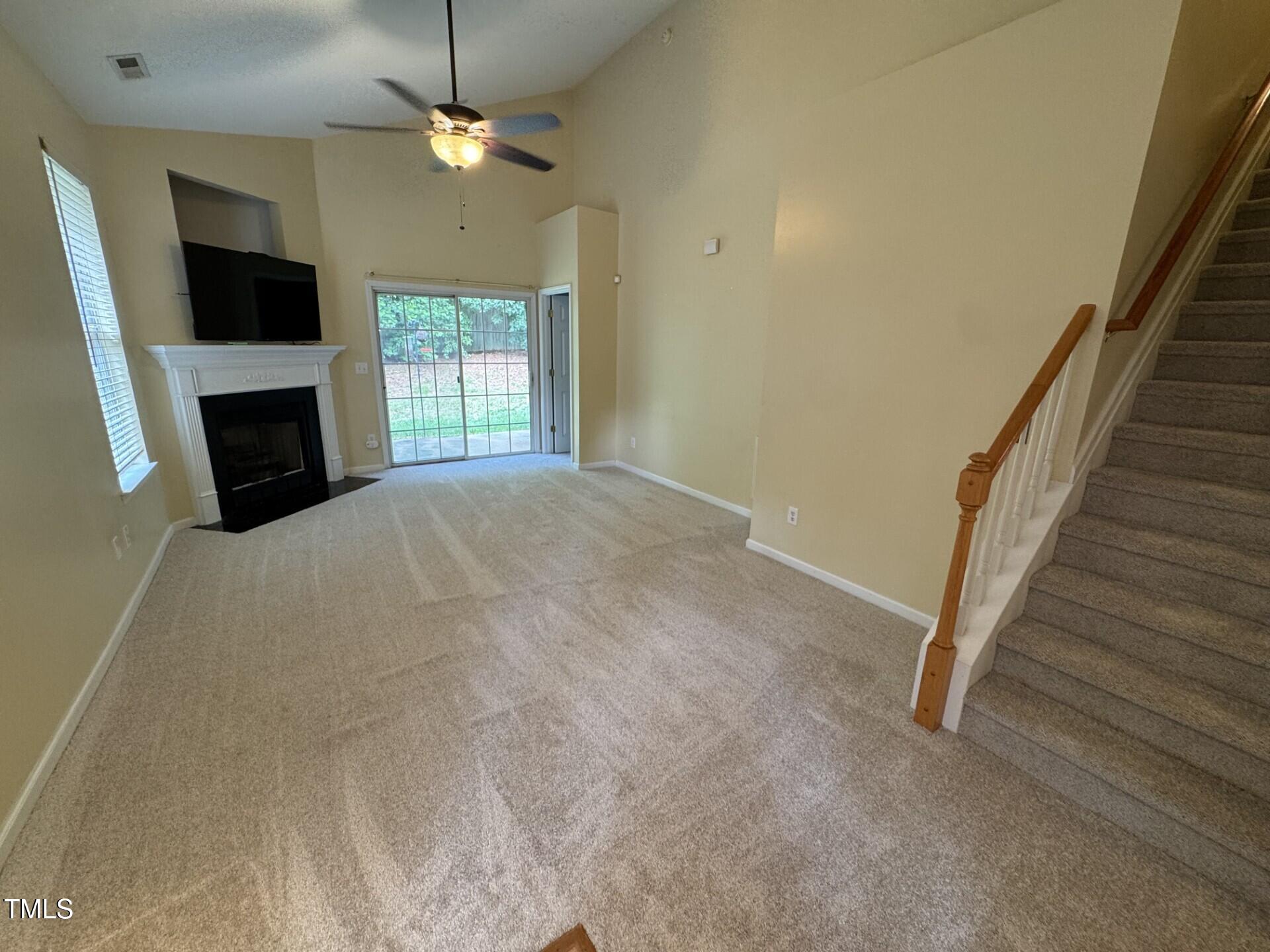 2250 Plum Frost Drive Raleigh, NC 27603 - Photo 4 of 19 a view of empty room with fireplace and flat screen tv