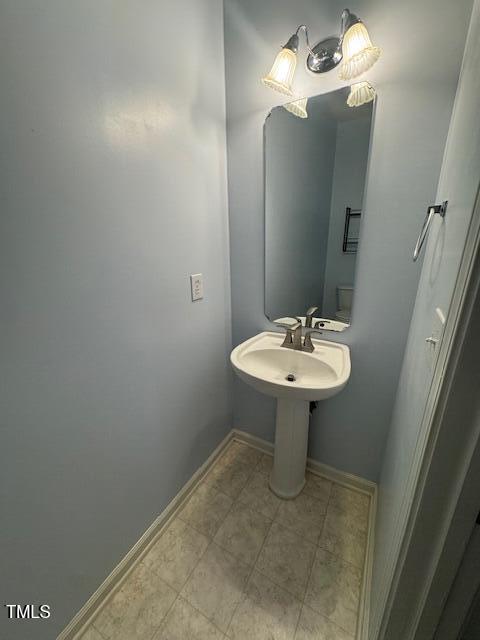 2250 Plum Frost Drive Raleigh, NC 27603 - Photo 9 of 19 a bathroom with a sink a light fixture and a mirror