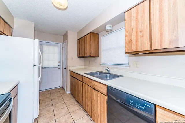 a kitchen with a sink and a refrigerator