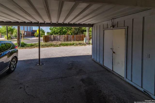 a view of porch with a table and chairs