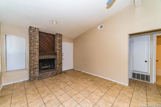 a view of an empty room and fire place