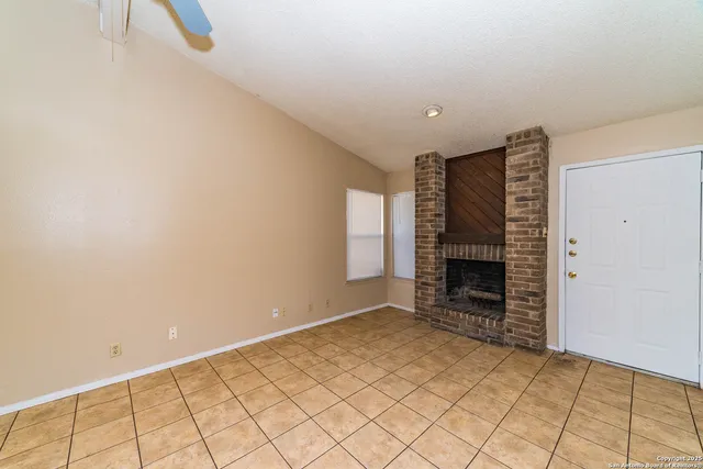 a view of an empty room with a fireplace