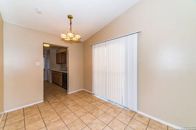 a view of a hallway with wooden floor and a kitchen