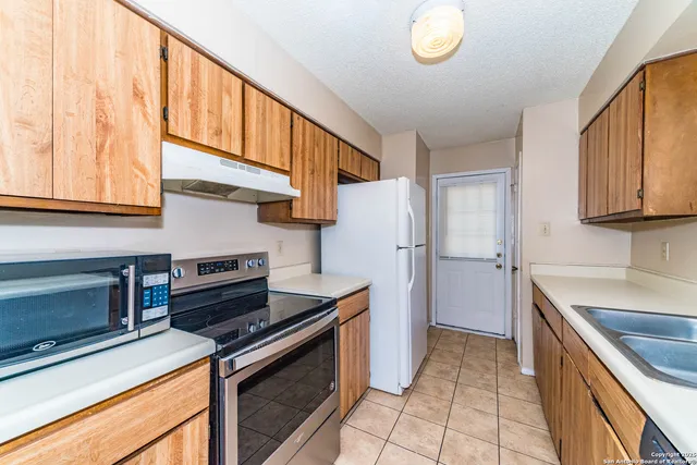 a kitchen with a stove and a sink