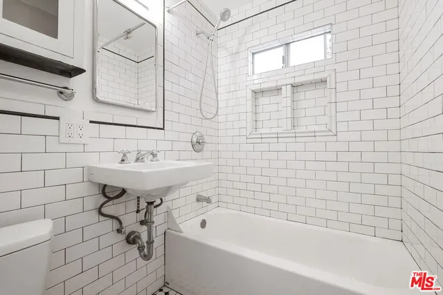 a bathroom with a sink a bathtub and shower