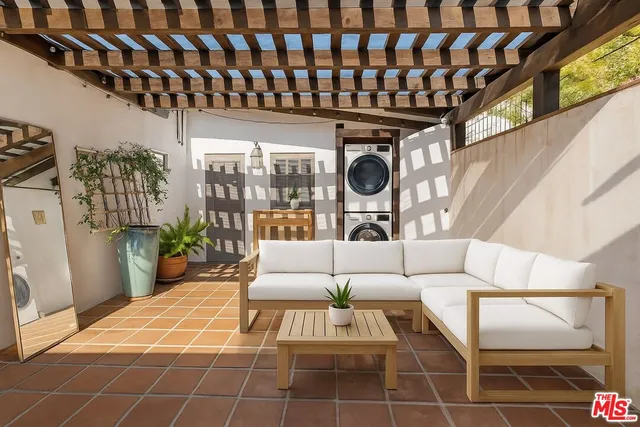 a living room with furniture a rug and white walls