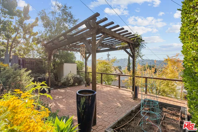 a view of a patio with table and chairs and potted plants