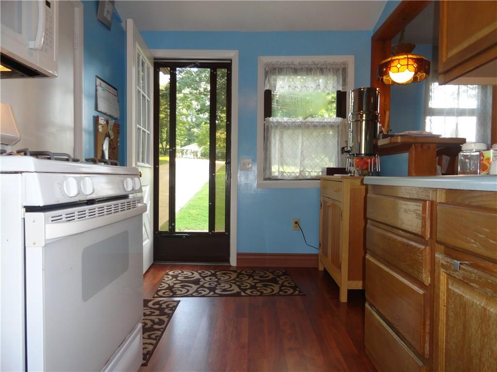 226 Oak Road Pittsburgh, PA 15239 - Photo 7 of 25 The kitchen has four entry doors - from the garage on the left, the front driveway straight ahead, the dining room on the right and a fourth door to the rear yard behind the photographer.