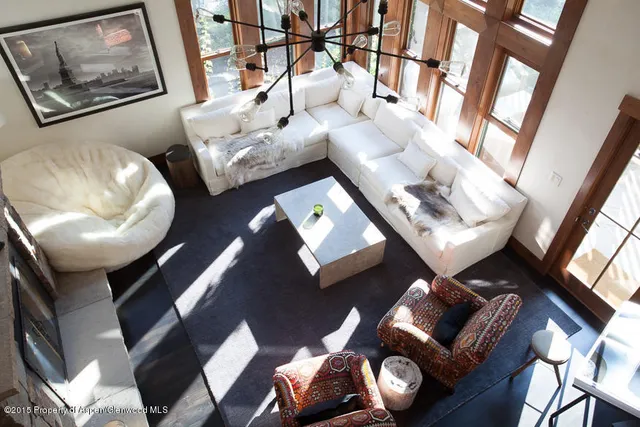 a living room with furniture and a mirror