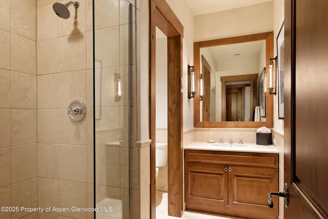 a bathroom with a shower and a sink