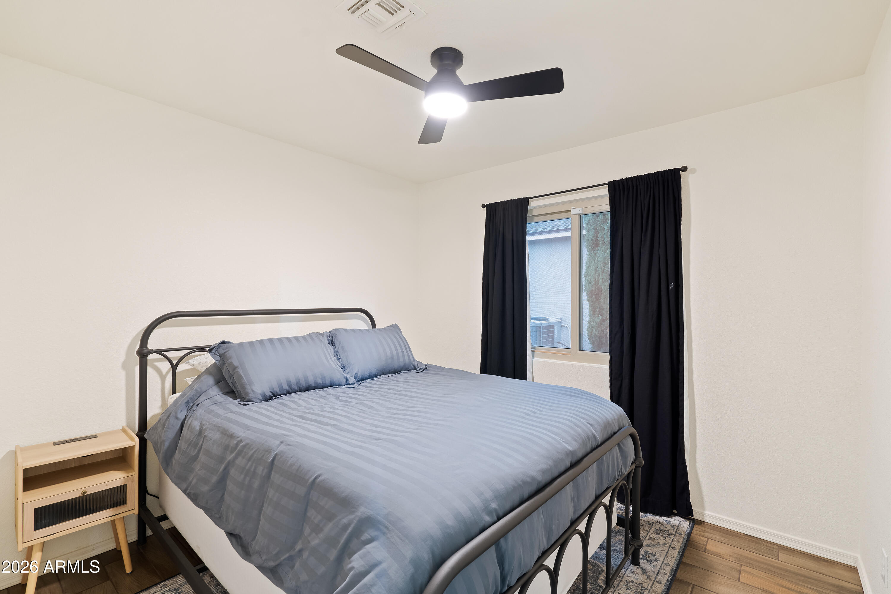 4591 Territorial Loop Sierra Vista, AZ 85635 - Photo 19 of 27 a bedroom with a large bed and a chandelier