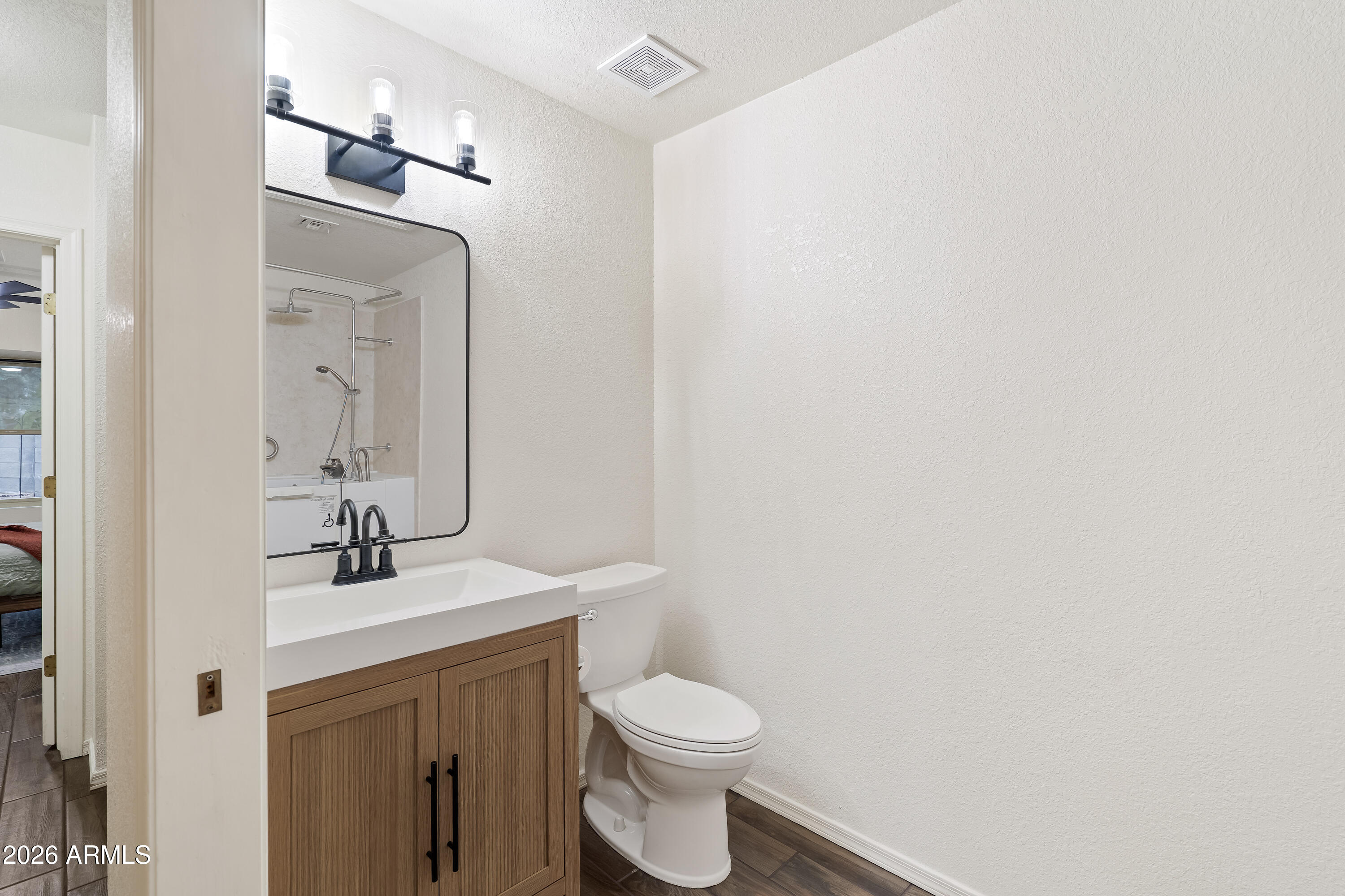 4591 Territorial Loop Sierra Vista, AZ 85635 - Photo 20 of 27 a bathroom with a sink a toilet and mirror