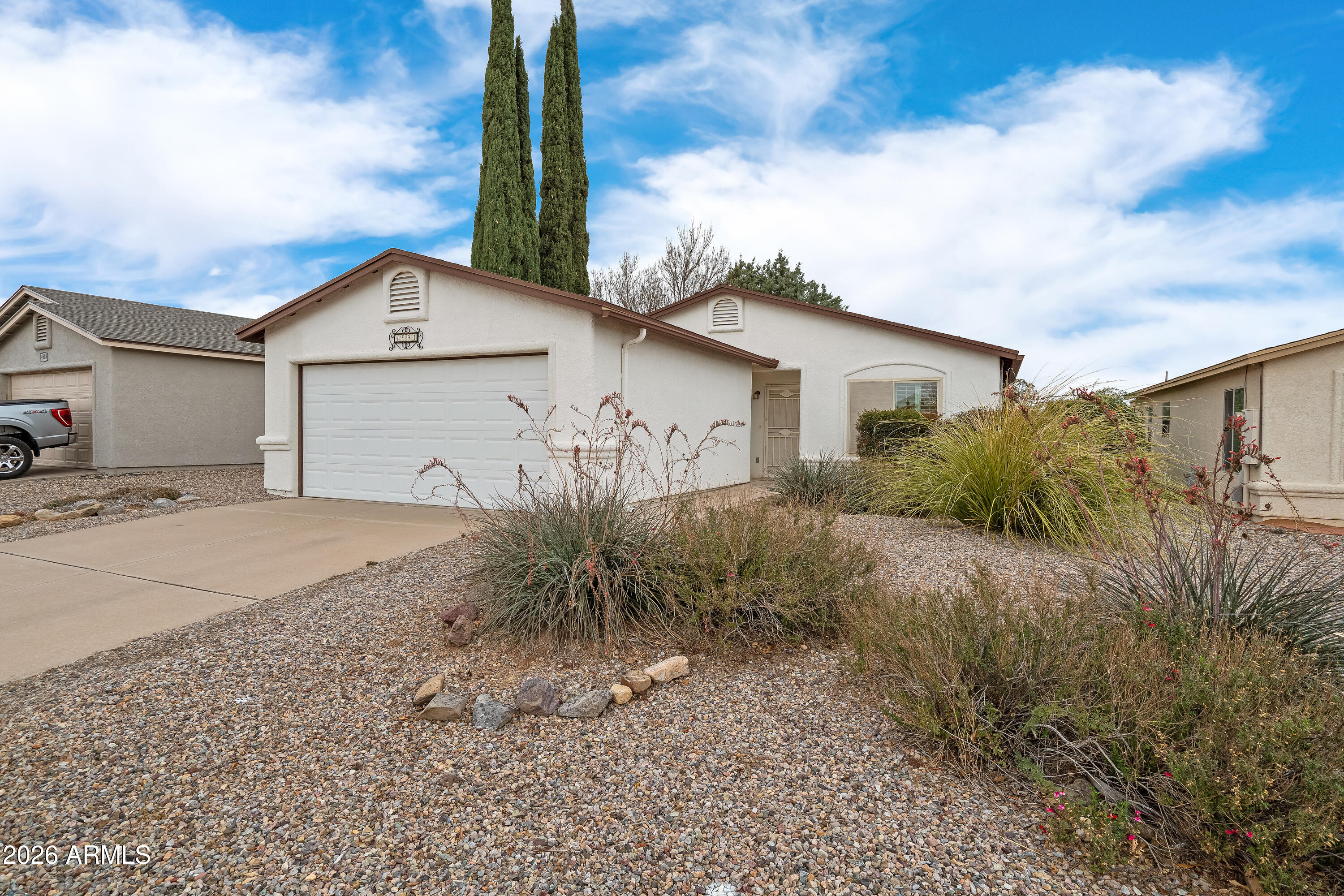 4591 Territorial Loop Sierra Vista, AZ 85635 - Photo 2 of 27 a front view of a house with garden